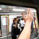 A commuter argues with a protester as a train is stalled during disruption of subway services by protesters, in Hong Kong, Aug. 5, 2019.